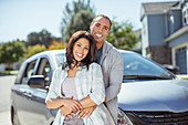 Portrait of smiling couple in driveway