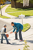 Father and son playing basketball