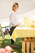 Smiling girl working lemonade stand
