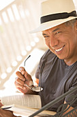 Portrait of smiling man reading book