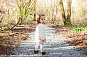 Baby girl walking on gravel path