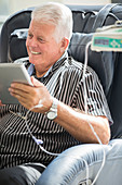 Senior man using tablet pc