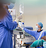 Two surgeons preparing medical equipment