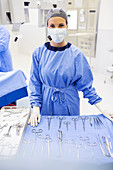 Surgical nurse behind medical tools