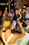Woman taking picture of friends at party