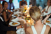 Woman clapping at dinner party