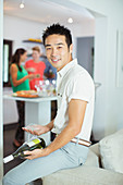 Man holding bottle of wine at party