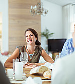 Woman laughing at dinner party