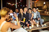 Woman taking picture of friends at party