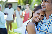 Couple hugging at dinner party