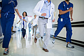 Doctors and nurses rushing hallway