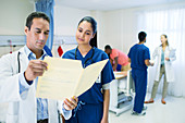 Doctor and nurse reading medical chart