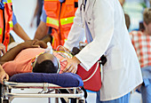 Doctor examining patient on stretcher