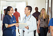 Doctor and nurse shaking hands hallway