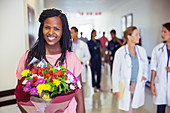 Patient holding bouquet of flowers