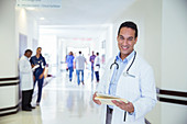 Doctor smiling in hospital hallway