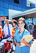 Nurse smiling outside hospital