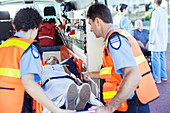 Paramedics examining patient in ambulance