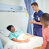 Nurse talking to patient in hospital room