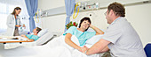 Man talking to wife in hospital room
