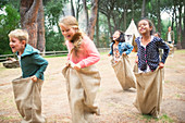 Children having sack race in field