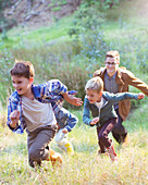 Boys running in field