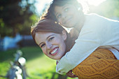 Mother carrying daughter on shoulders