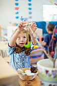 Student playing with model in classroom