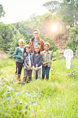 Students and teacher smiling in field