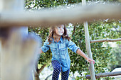 Girl climbing on play structure