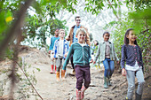 Students and teacher walking in forest