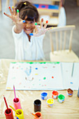 Student finger painting in classroom