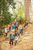 Students and teachers walking in forest