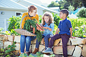 Teacher and students in vegetable garden