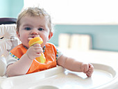 Baby girl chewing on toy