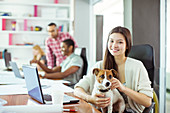 Woman petting dog in office