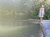 Woman walking by edge of pool