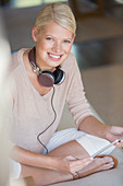 Woman using digital tablet on sofa