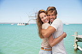 Couple hugging near water