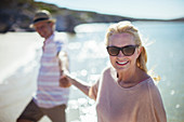 Couple holding hands on beach