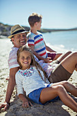 Family sitting in sand together