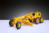 Model of road grader on pedestal