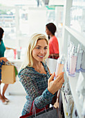 Woman examining skincare product