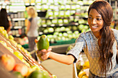 Woman shopping for fruit in grocery store