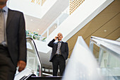Businessman talking at top of stairs