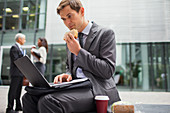 Businessman eating lunch while working