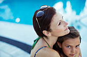 Pensive woman sitting with daughter