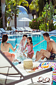 Family with two children splashing water