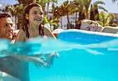 Girl swimming with her parents