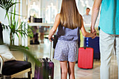 Father and daughter with suitcases